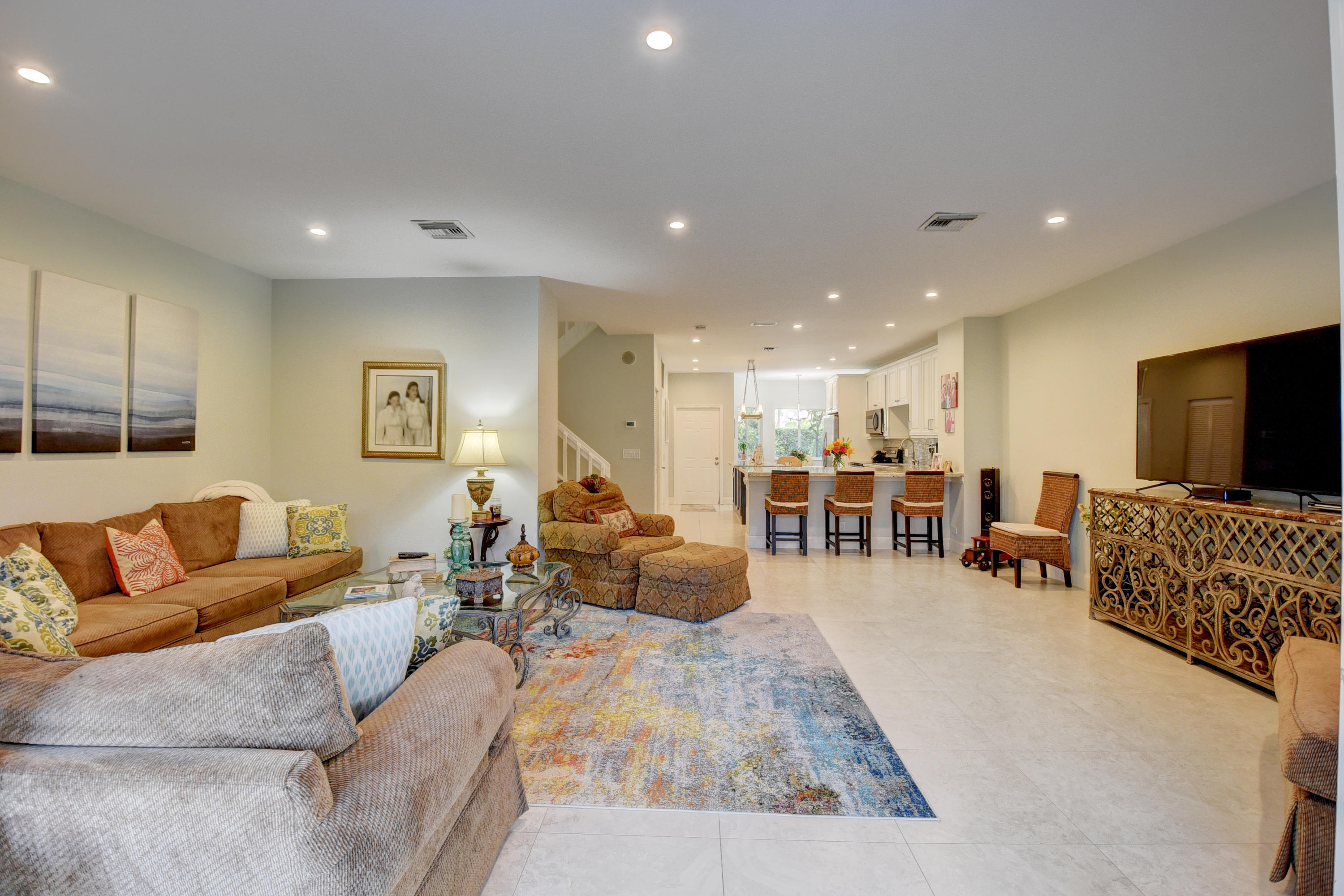 6817 Via Regina Boca Raton, FL 33433 - Photo 11 of 42 a living room with furniture and a flat screen tv
