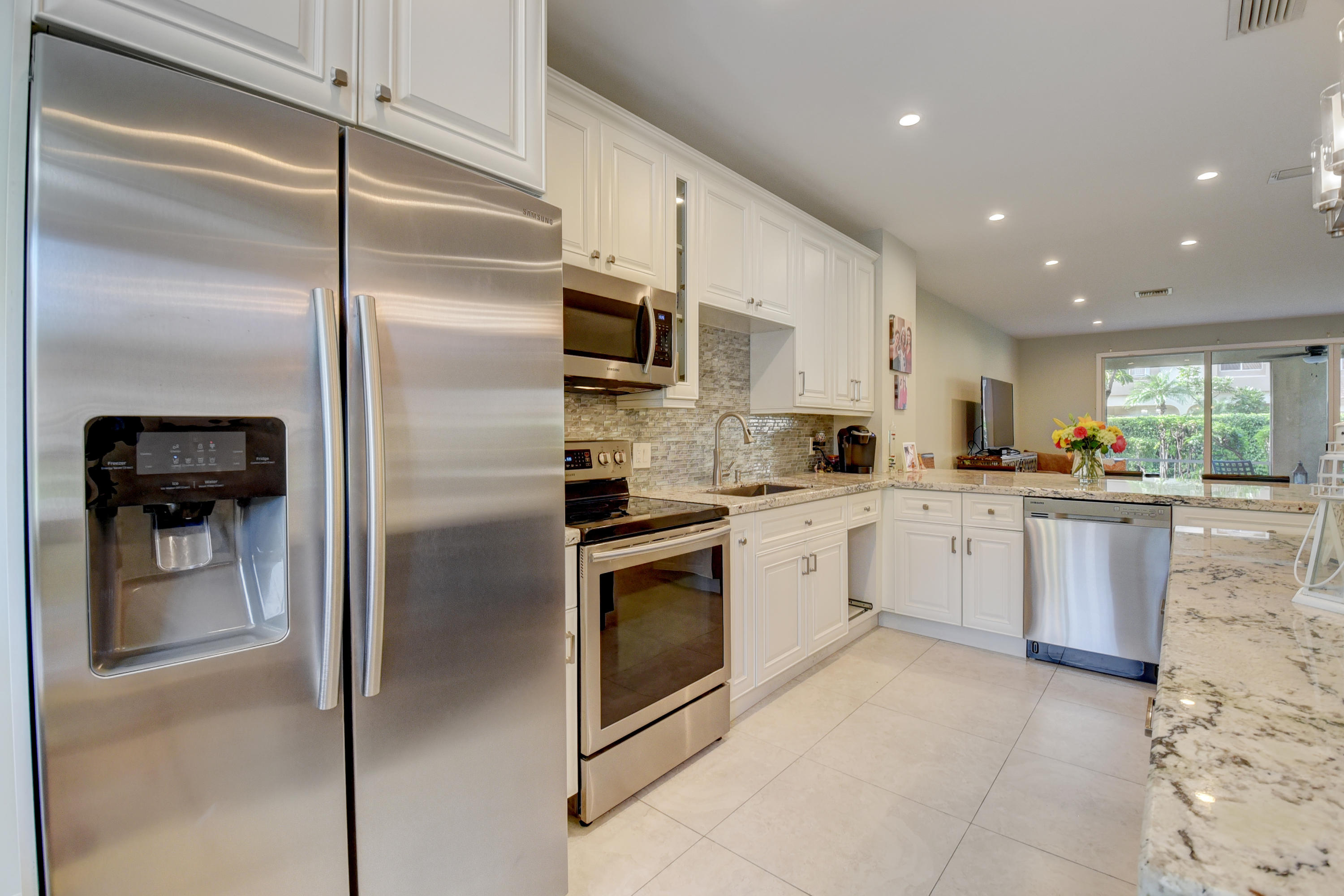 6817 Via Regina Boca Raton, FL 33433 - Photo 15 of 42 a kitchen with a refrigerator and a oven