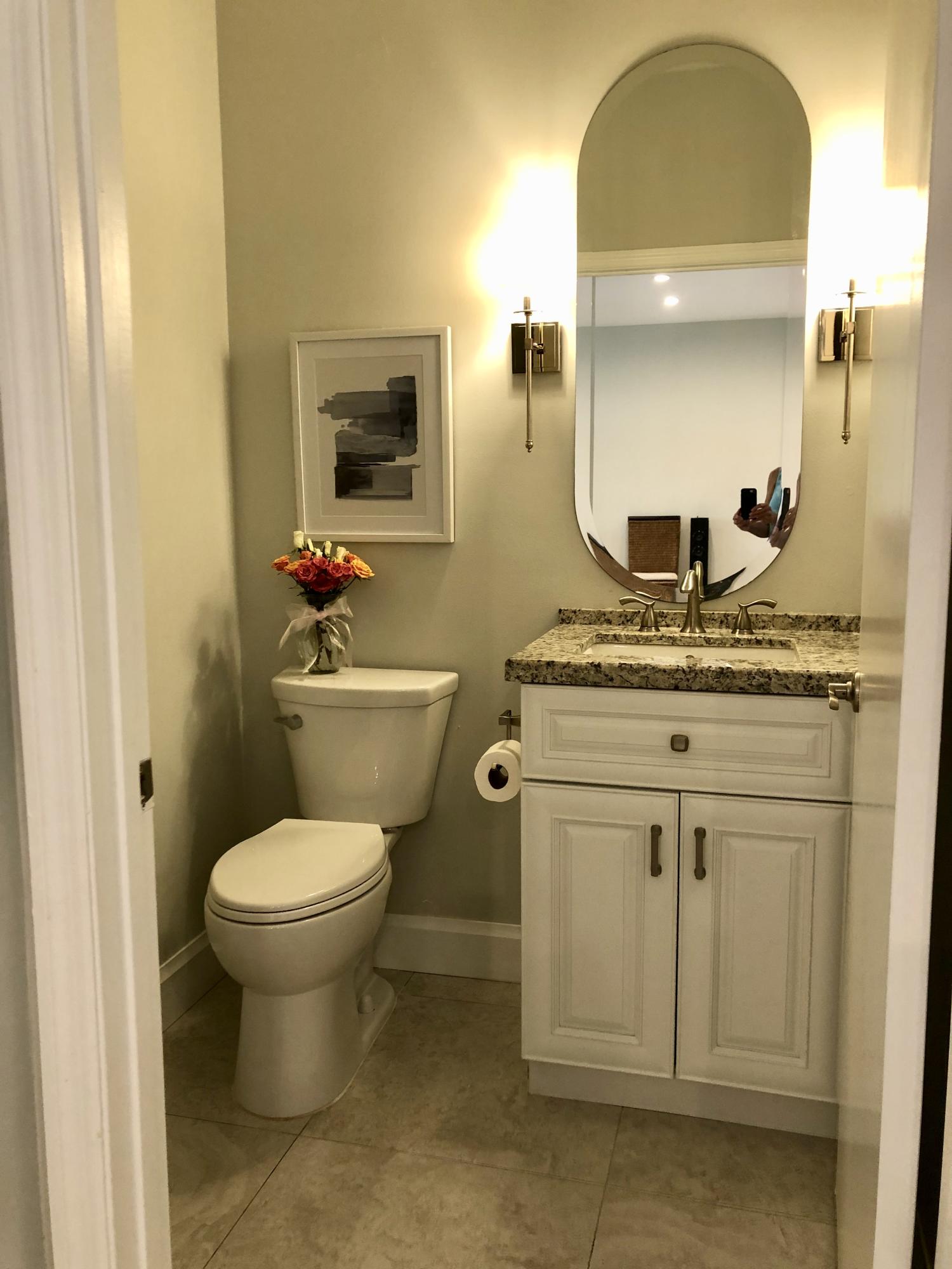 6817 Via Regina Boca Raton, FL 33433 - Photo 18 of 42 a bathroom with a granite countertop toilet sink and mirror