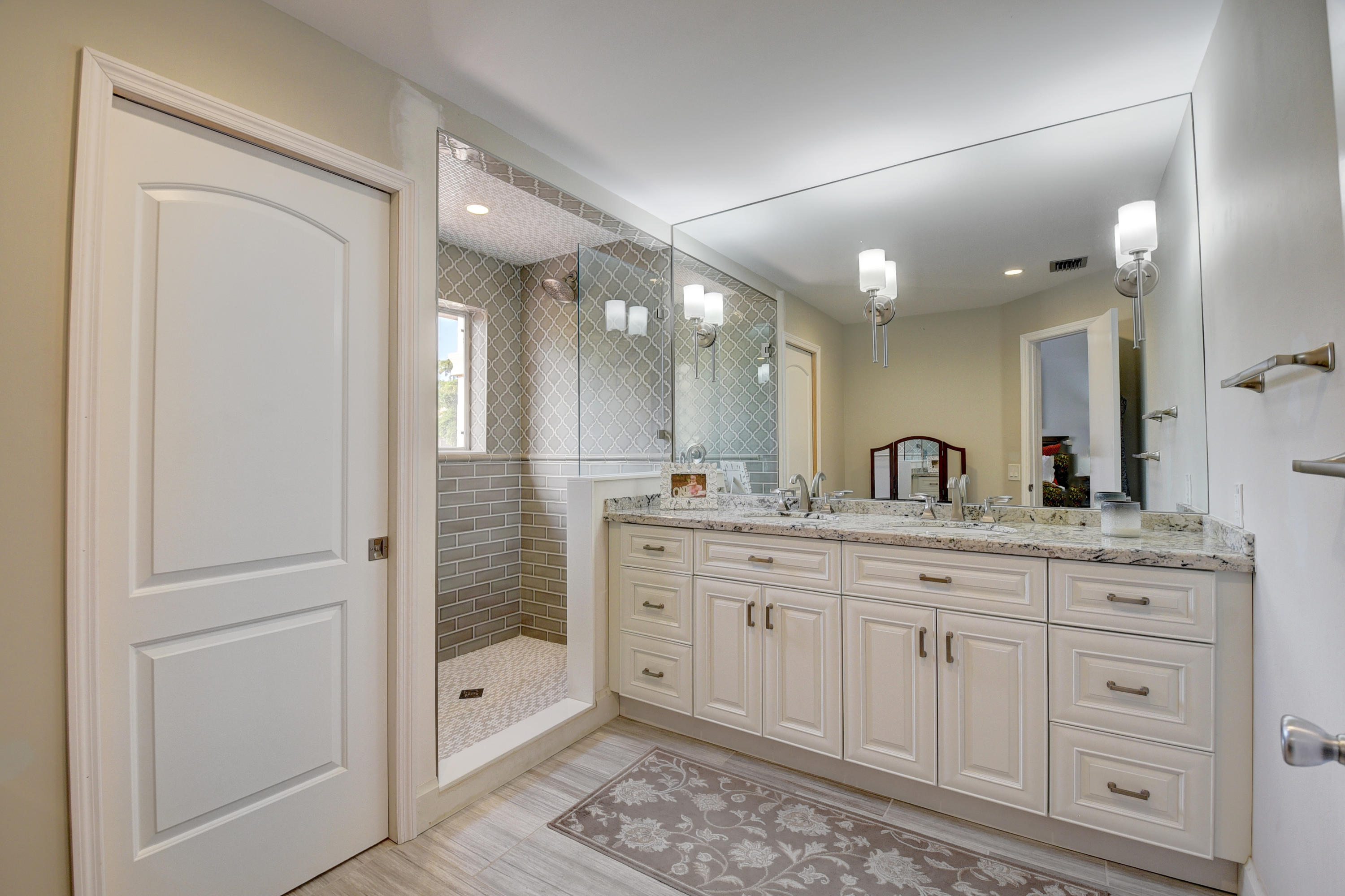 6817 Via Regina Boca Raton, FL 33433 - Photo 23 of 42 a spacious bathroom with a granite countertop sink mirror and shower