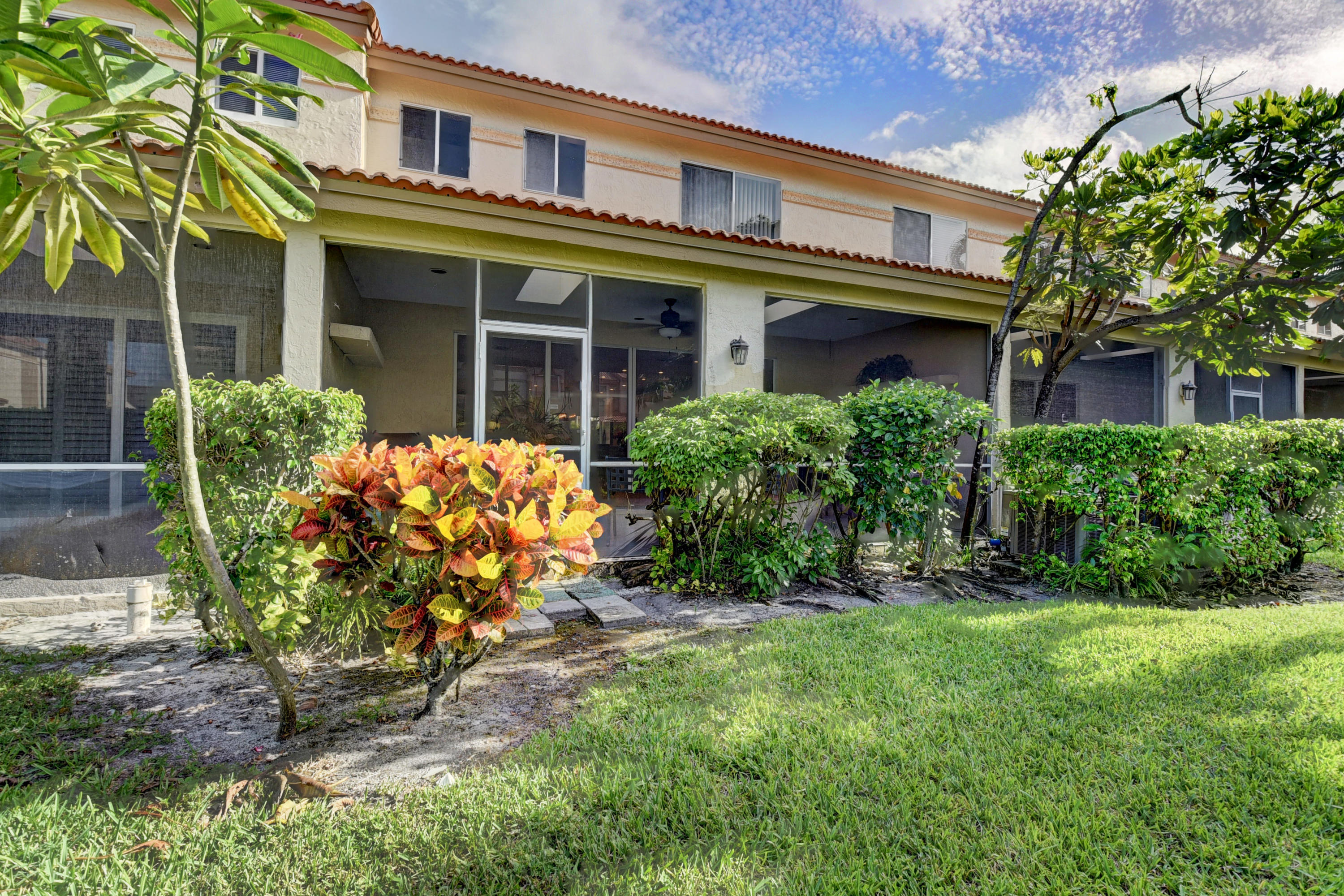 6817 Via Regina Boca Raton, FL 33433 - Photo 39 of 42 front view of a brick house with a yard