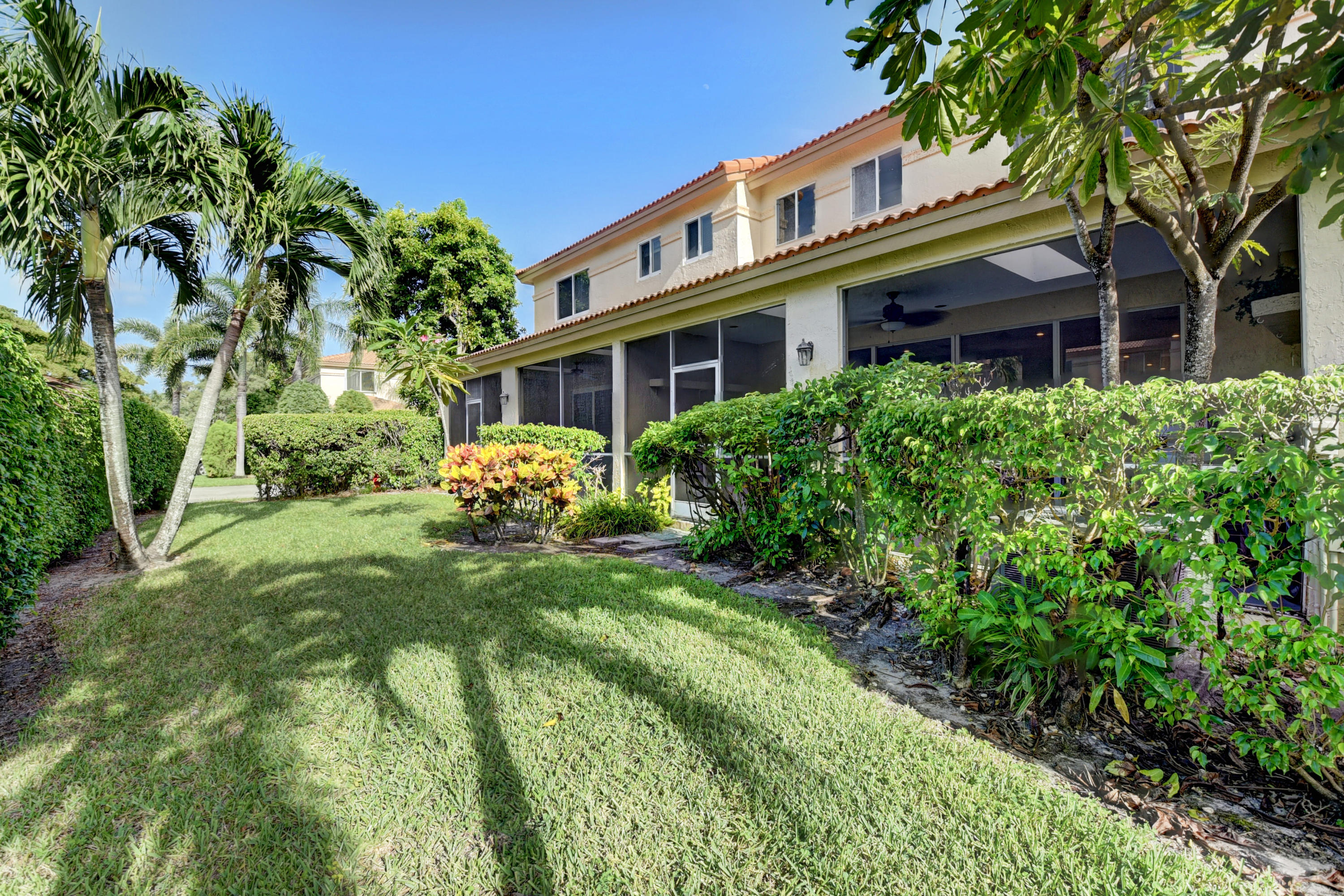 6817 Via Regina Boca Raton, FL 33433 - Photo 40 of 42 a front view of a house with garden