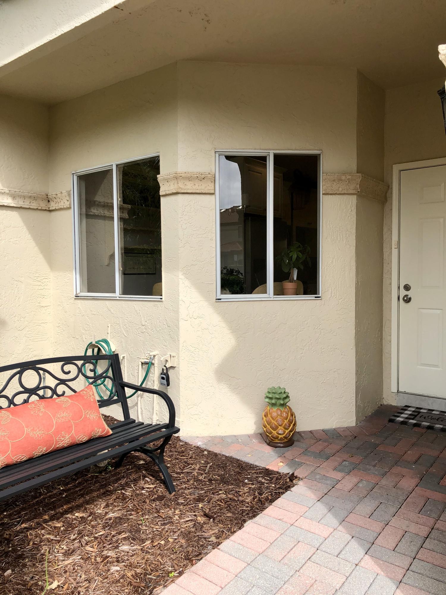 6817 Via Regina Boca Raton, FL 33433 - Photo 5 of 42 a view of a chairs and table in back yard of the house