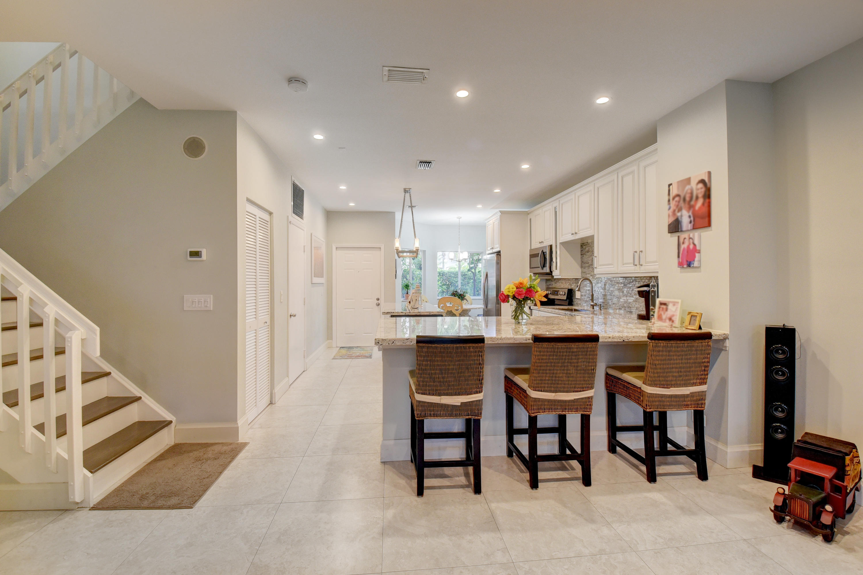 6817 Via Regina Boca Raton, FL 33433 - Photo 6 of 42 a open kitchen with dining table and chairs
