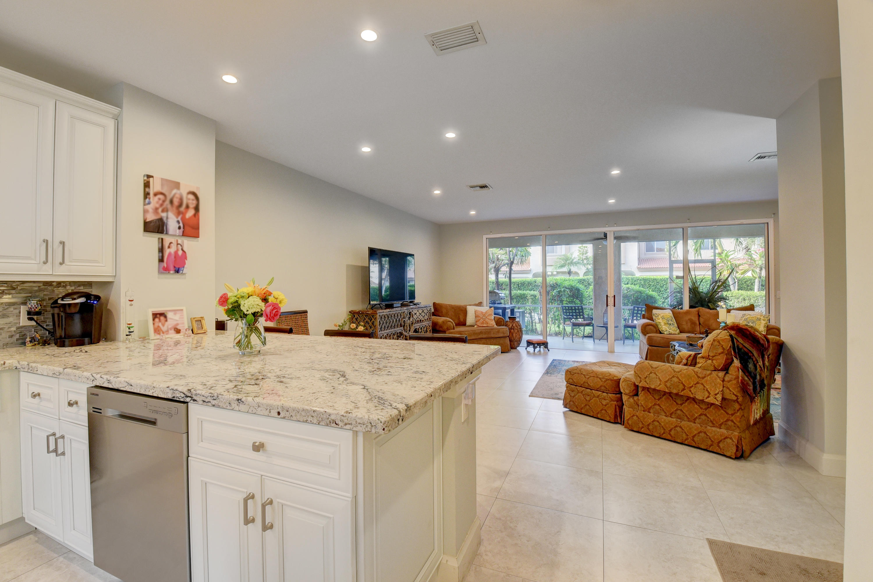 6817 Via Regina Boca Raton, FL 33433 - Photo 8 of 42 a view of living room kitchen with stainless steel appliances granite countertop cabinets and a counter top space