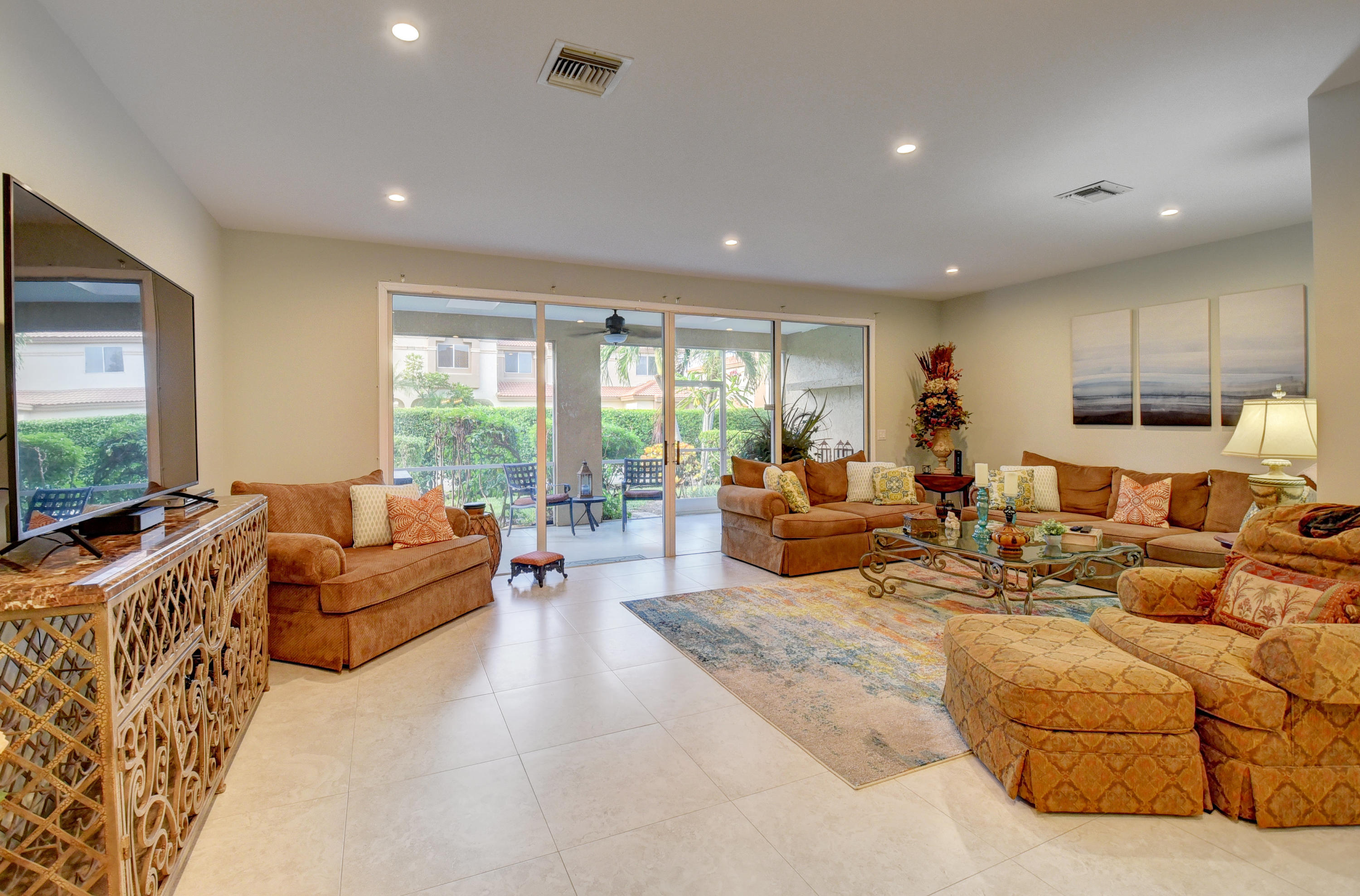 6817 Via Regina Boca Raton, FL 33433 - Photo 10 of 42 a living room with furniture and a flat screen tv