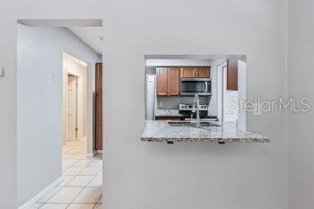 907 Center Avenue, Unit 5 Haines City, FL 33844 - Photo 7 of 15 a view of kitchen with granite countertop window