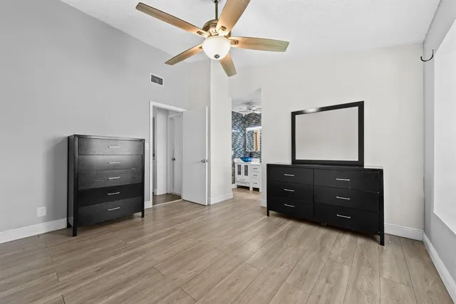 a living room with a dresser with wooden floor