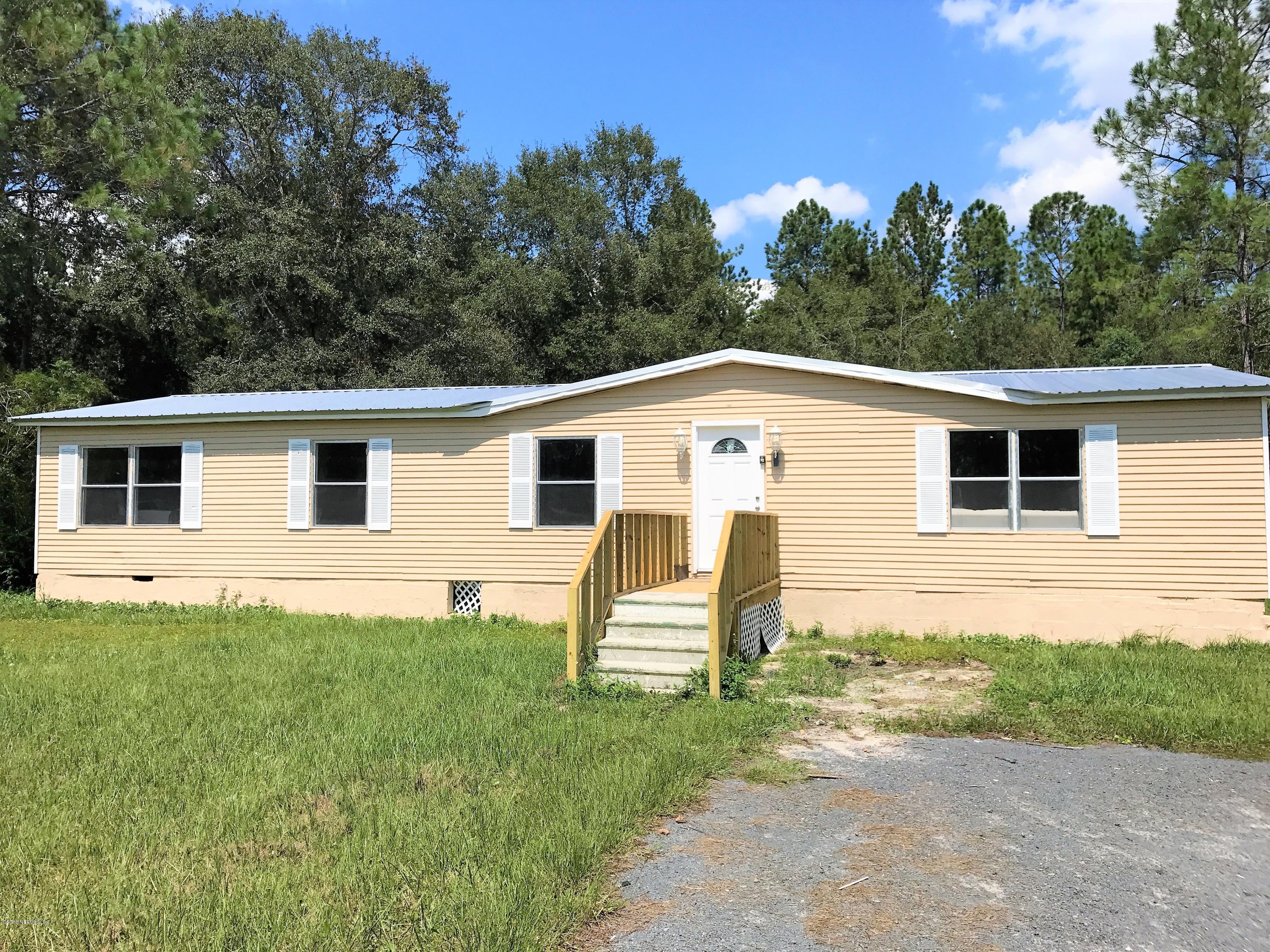 5709 North Tall Pine Road Macclenny, FL 32063 - Photo 1 of 10 a view of a house with a backyard