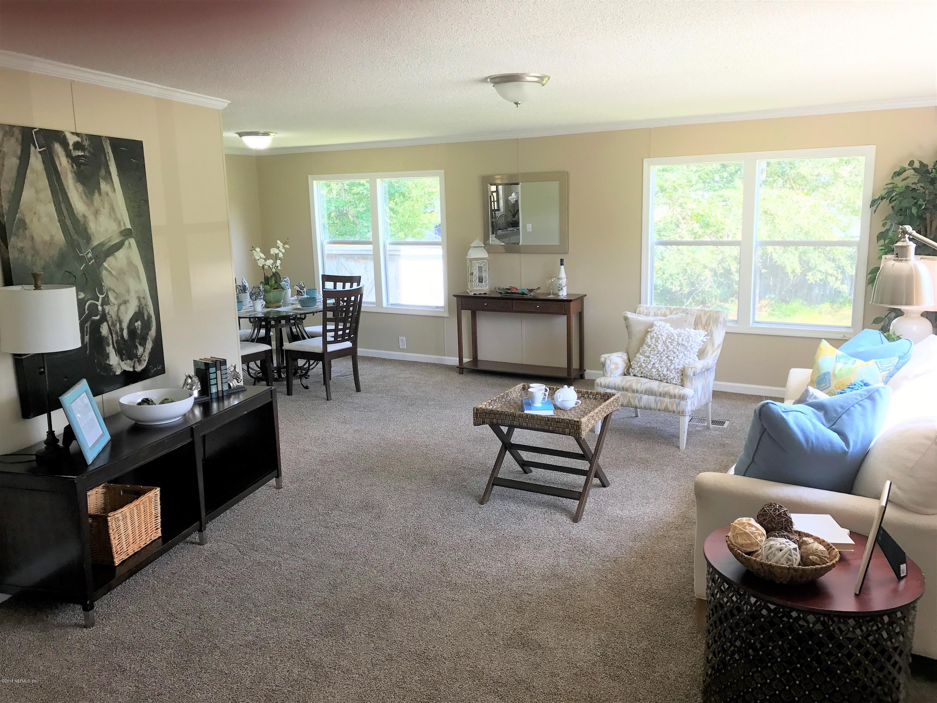 5709 North Tall Pine Road Macclenny, FL 32063 - Photo 2 of 10 a living room with furniture and a large window