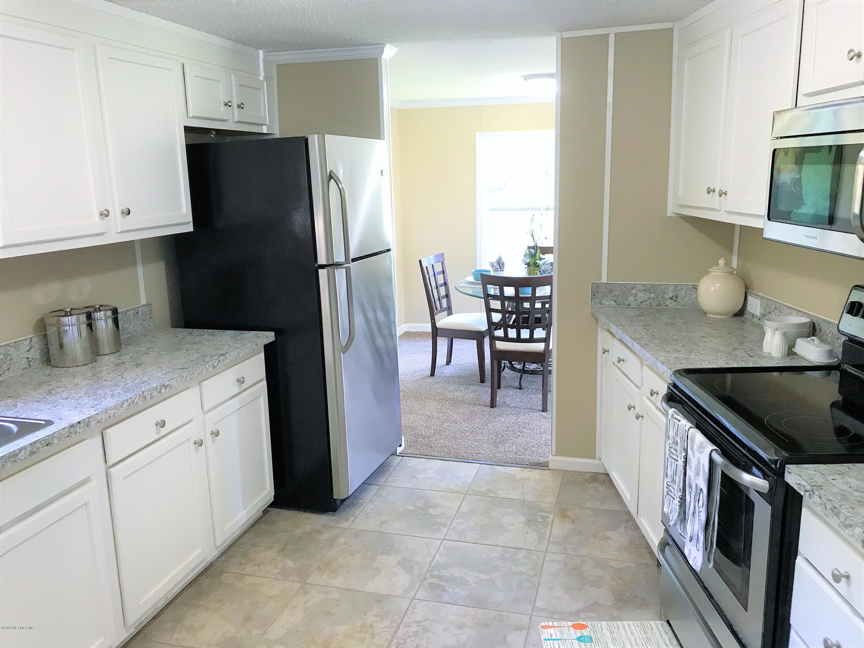 5709 North Tall Pine Road Macclenny, FL 32063 - Photo 5 of 10 a kitchen with granite countertop a refrigerator stove and sink