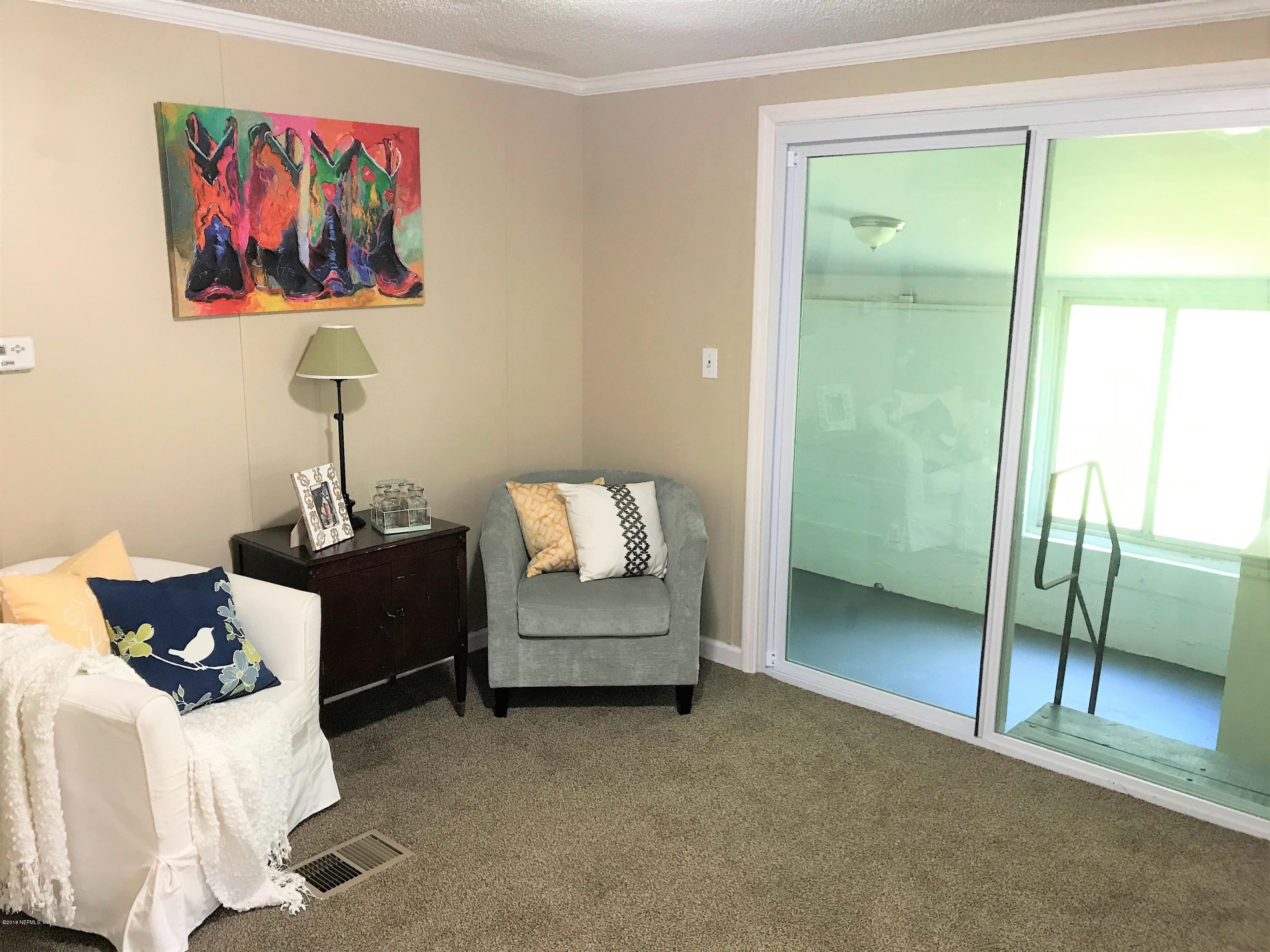 5709 North Tall Pine Road Macclenny, FL 32063 - Photo 6 of 10 a bedroom with furniture and a gate