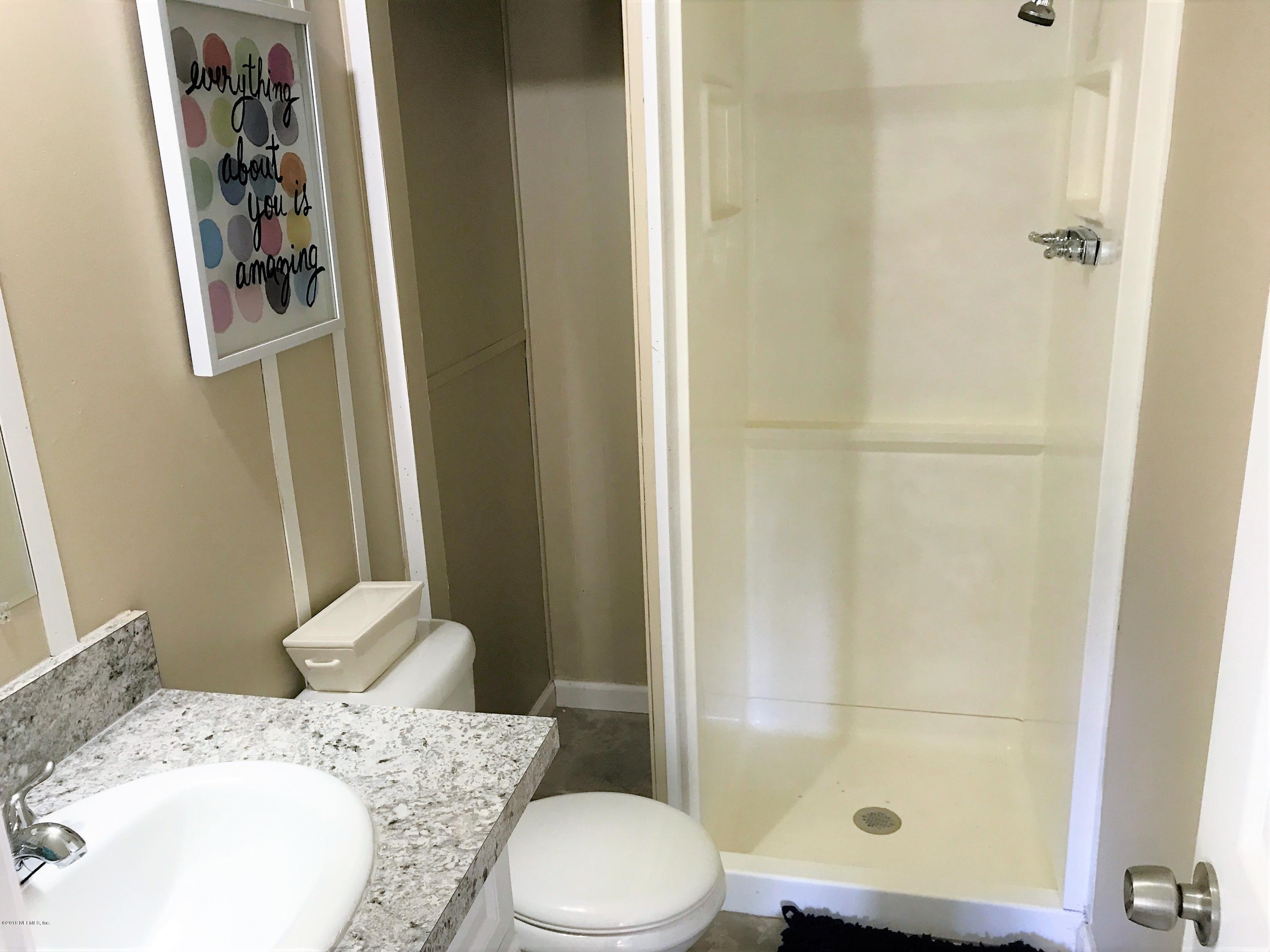 5709 North Tall Pine Road Macclenny, FL 32063 - Photo 7 of 10 a bathroom with a sink toilet and shower