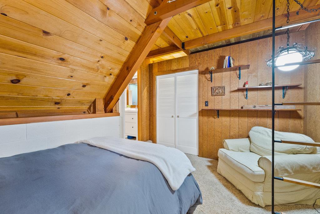 621 Hidden Canyon Watsonville, CA 95076 - Photo 22 of 55 a bedroom with a bed and a chandelier