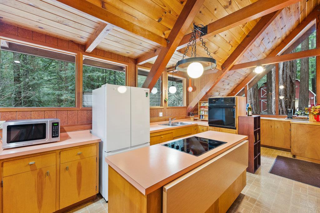 621 Hidden Canyon Watsonville, CA 95076 - Photo 10 of 55 a kitchen with stainless steel appliances granite countertop a refrigerator a stove and a microwave with couches