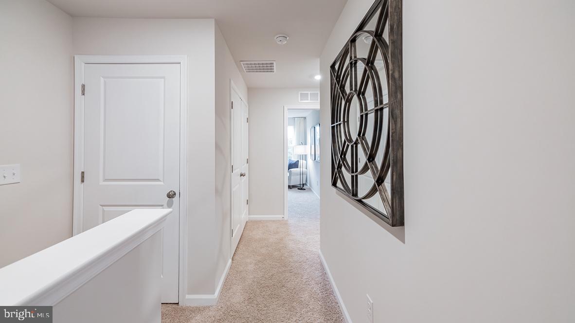 95 Alexander Way Westampton, NJ 08060 - Photo 20 of 24 a view of a hallway with wooden floor and staircase