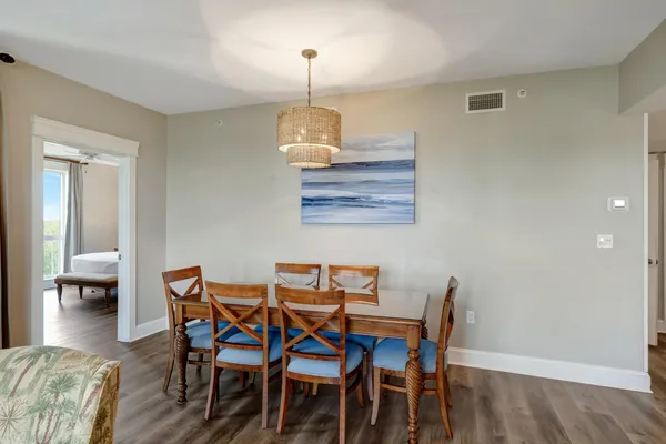 a living room with furniture a flat screen tv and floor to ceiling window