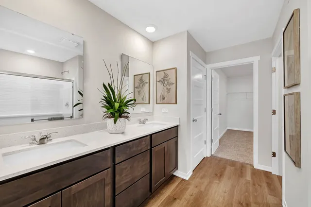 a bathroom with a double vanity sink and mirror