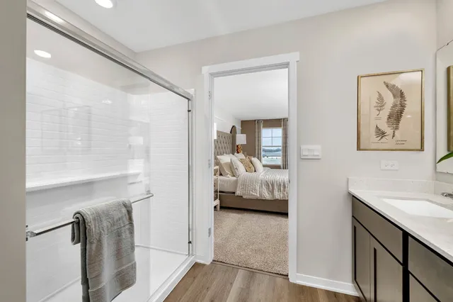 a en suite bathroom with a tub shower and sink