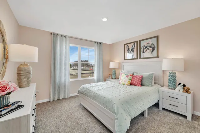 a bedroom with a bed and closet with mirror