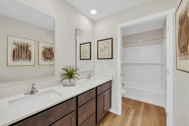 a bathroom with a sink double vanity and a shower