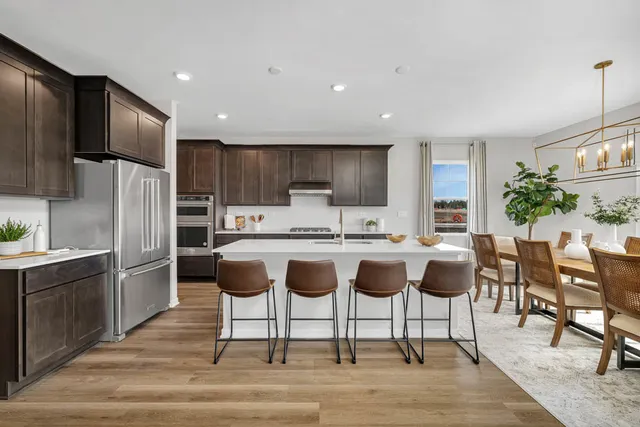 a kitchen with granite countertop a center island stainless steel appliances cabinets and a counter top space