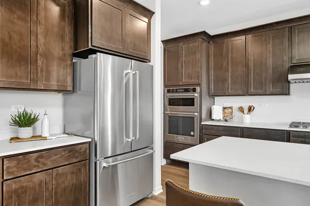 a kitchen with stainless steel appliances a refrigerator and a sink