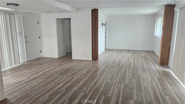 a view of a room with wooden floor