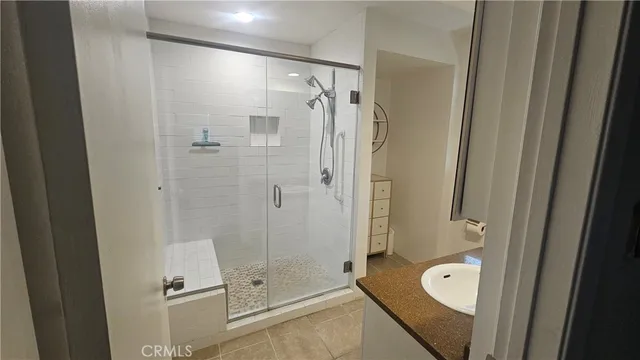 a bathroom with a shower and a sink