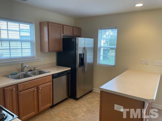 7831 Averette Field Drive Raleigh, NC 27616 - Photo 11 of 20 a kitchen with a sink a refrigerator and window