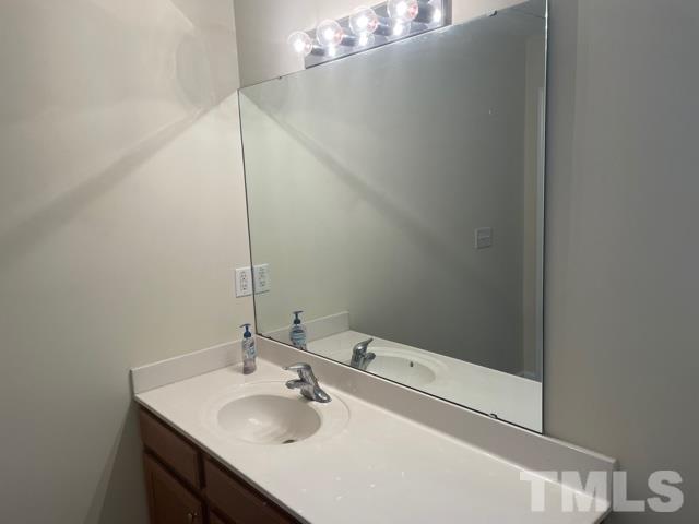 7831 Averette Field Drive Raleigh, NC 27616 - Photo 17 of 20 a bathroom with a sink and a mirror