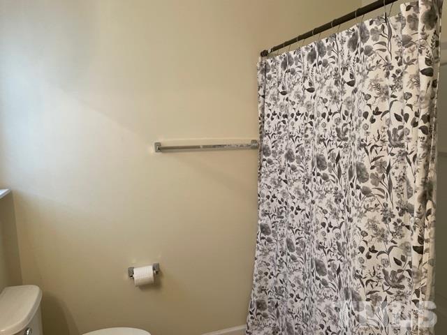 7831 Averette Field Drive Raleigh, NC 27616 - Photo 18 of 20 a bathroom with a shower curtain