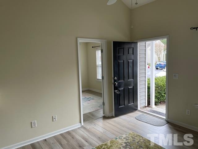 7831 Averette Field Drive Raleigh, NC 27616 - Photo 4 of 20 a view of a hallway with wooden floor and a bathroom