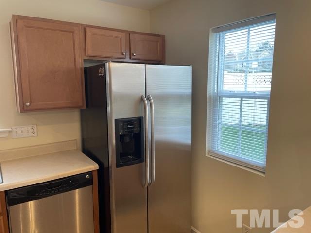7831 Averette Field Drive Raleigh, NC 27616 - Photo 8 of 20 a metallic refrigerator freezer sitting in a kitchen