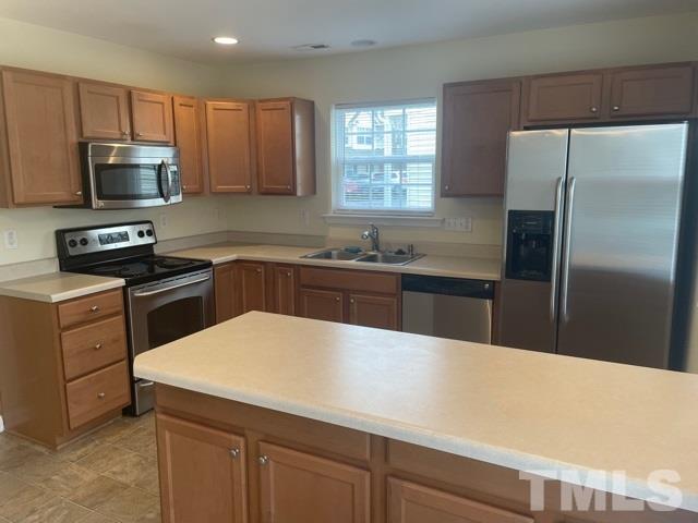 7831 Averette Field Drive Raleigh, NC 27616 - Photo 10 of 20 a kitchen with stainless steel appliances a sink dishwasher stove refrigerator and microwave