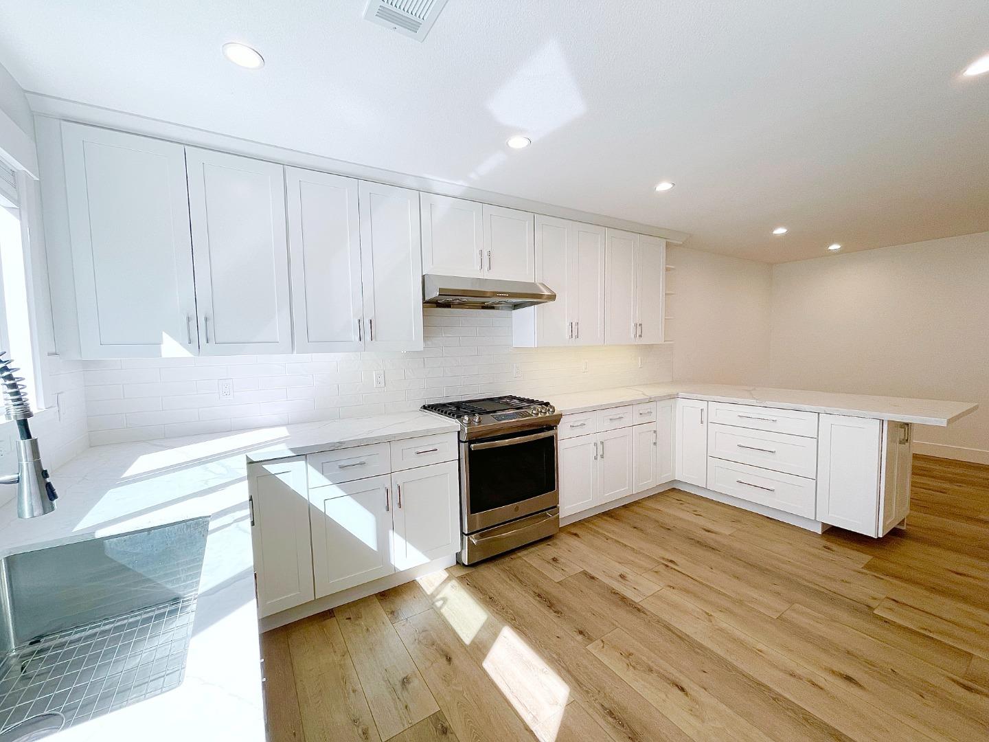 808 Sonia Way Mountain View, CA 94040 - Photo 10 of 20 a kitchen with a white cabinets and wooden floor