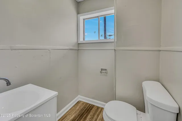a view of a room with wooden floor and cabinet
