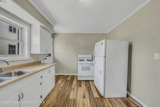 a front view of a building with a garden