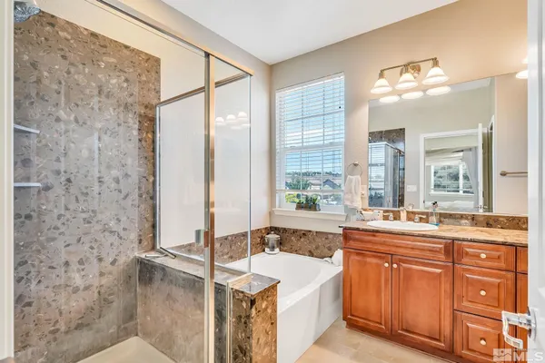 a bathroom with a tub sink and mirror