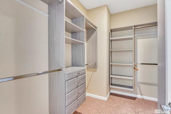 a view of walk in closet with empty racks