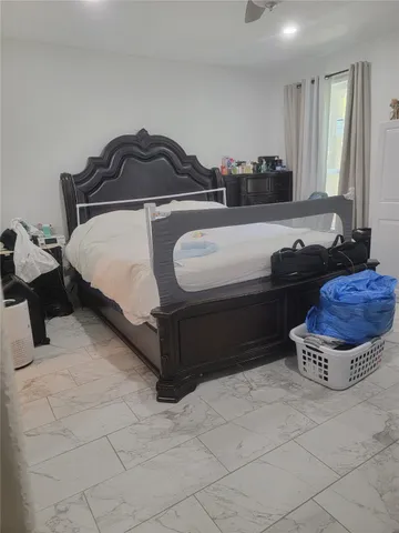 a spacious bedroom with a bed and window