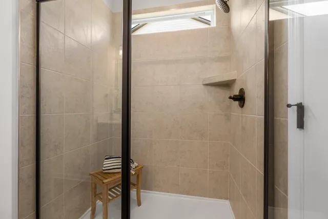 a en suite bathroom with double vanity and a mirror