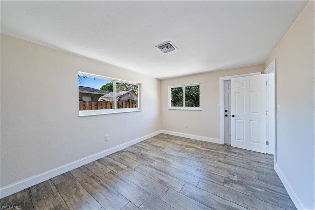 2545 Dawn Circle Naples, FL 34103 - Photo 11 of 20 a view of empty room with wooden floor and window