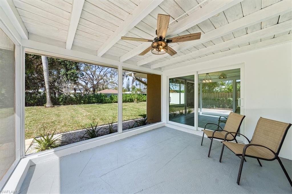 2545 Dawn Circle Naples, FL 34103 - Photo 16 of 20 a view of a porch with furniture and a yard