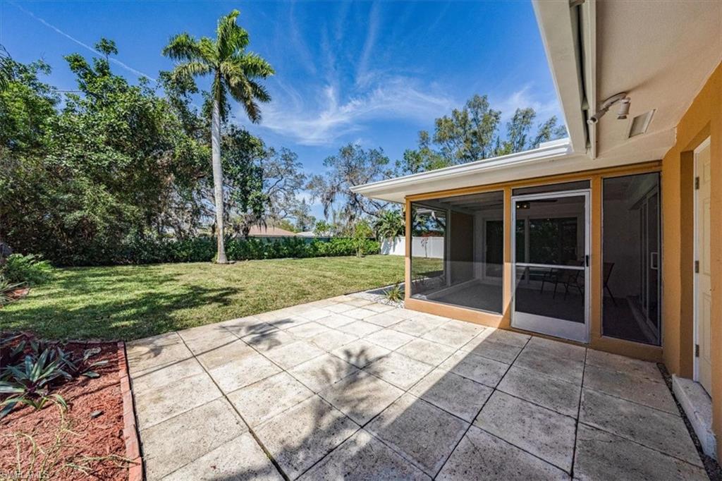 2545 Dawn Circle Naples, FL 34103 - Photo 17 of 20 a view of house with backyard and garden