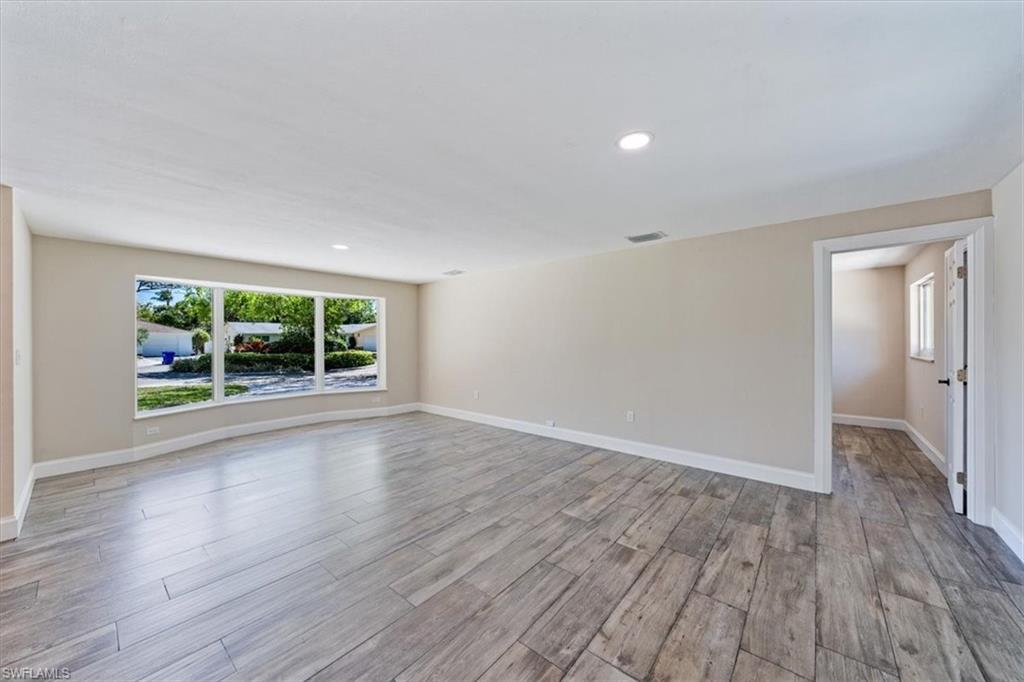 2545 Dawn Circle Naples, FL 34103 - Photo 3 of 20 wooden floor in an empty room with a window