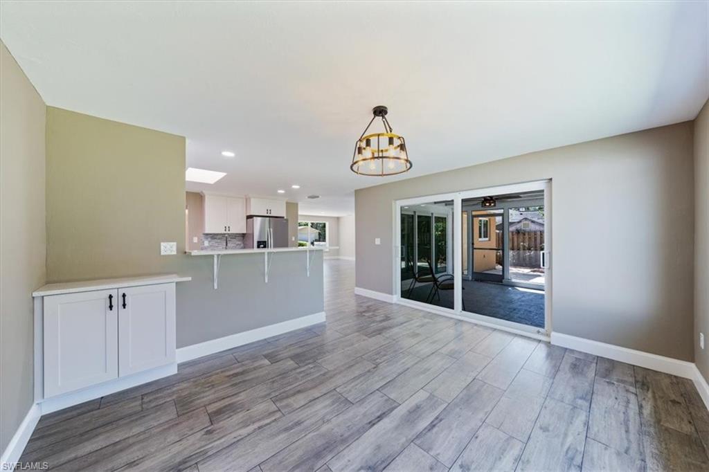 2545 Dawn Circle Naples, FL 34103 - Photo 5 of 20 a view of a kitchen with wooden floor and windows