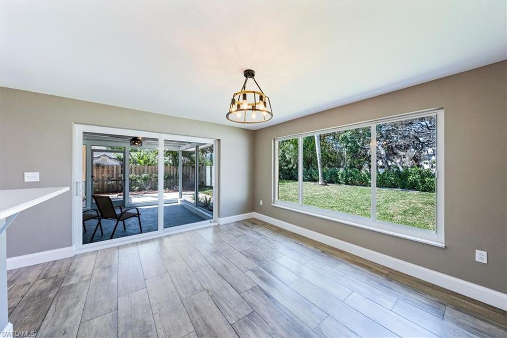 2545 Dawn Circle Naples, FL 34103 - Photo 6 of 20 a view of a room with wooden floor and outdoor space