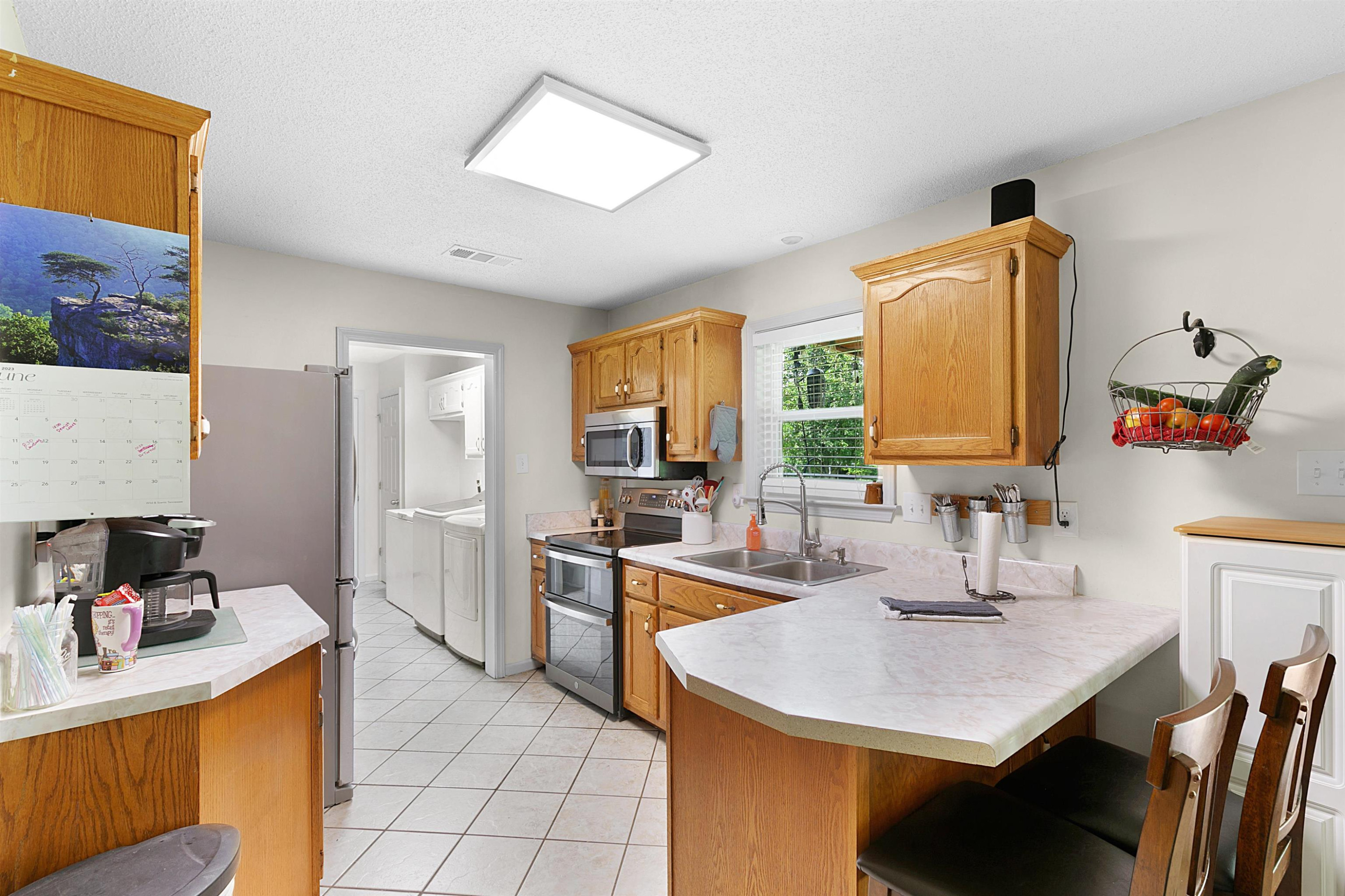 3225 Pickens Store Road Mason, TN 38049 - Photo 11 of 32 a kitchen with a sink refrigerator and cabinets