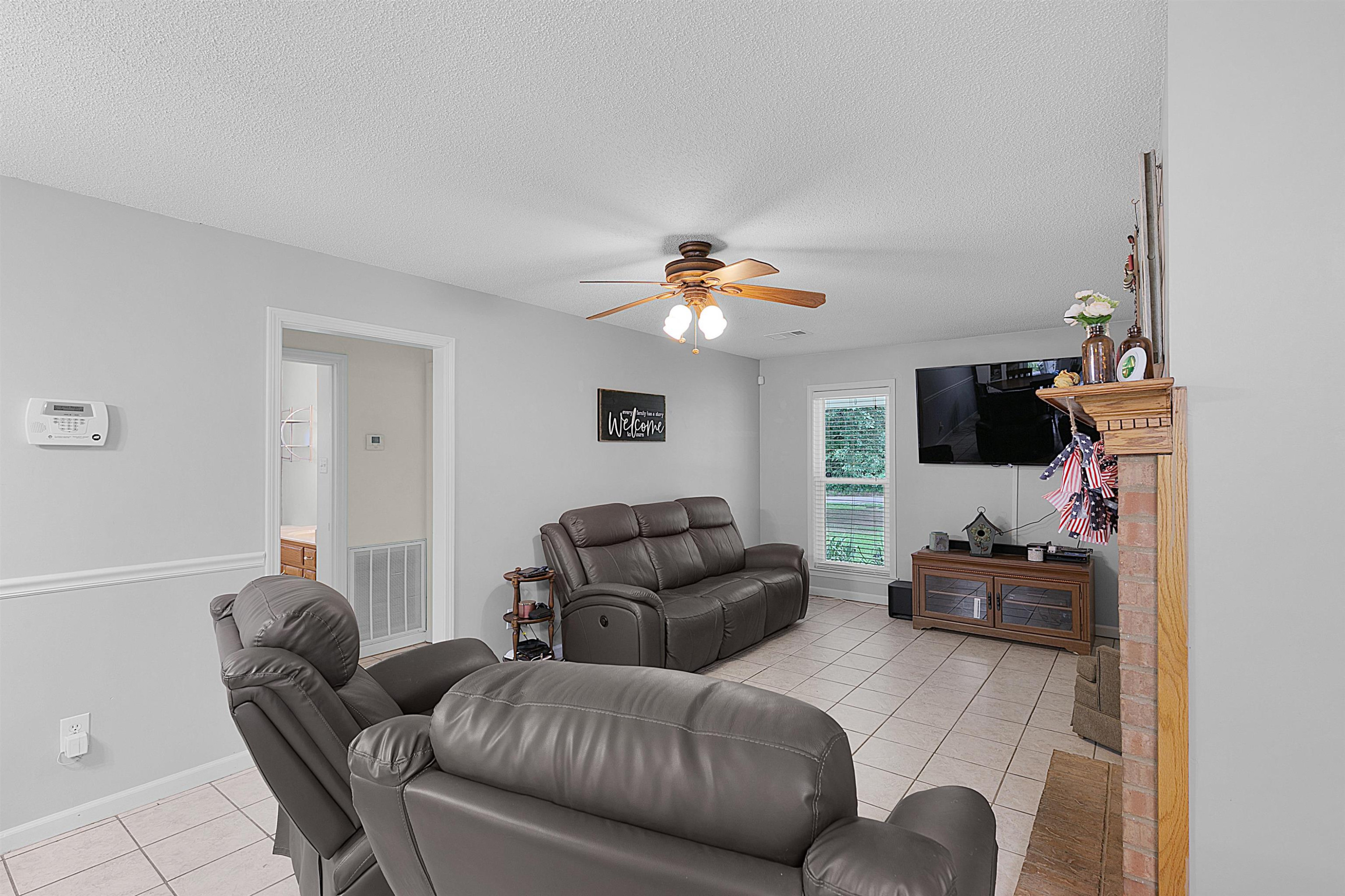 3225 Pickens Store Road Mason, TN 38049 - Photo 18 of 32 a living room with furniture and a flat screen tv